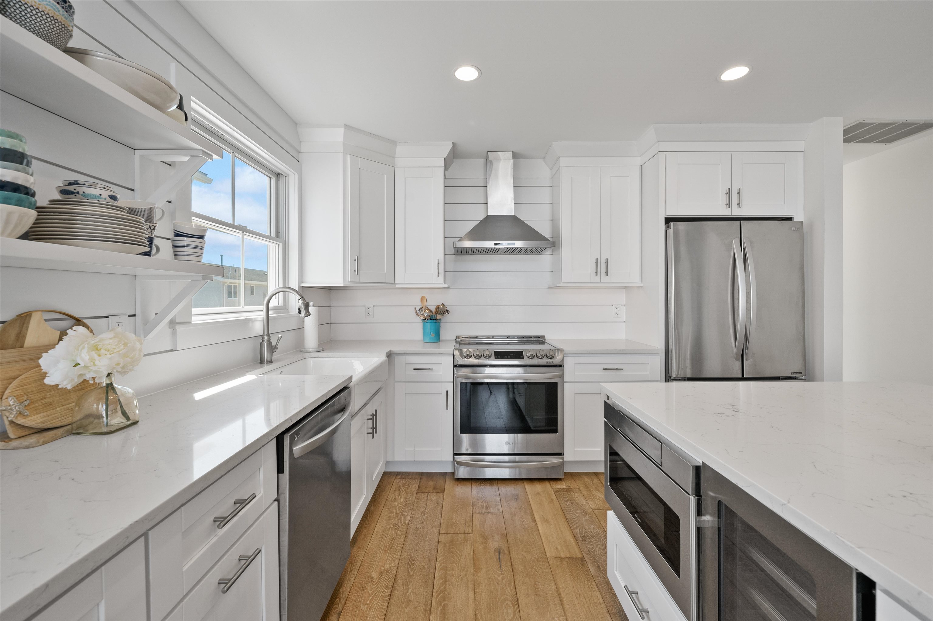 360 39th Street, Unit EAST Avalon, NJ 08202 - Photo 7 of 28 a kitchen with stainless steel appliances granite countertop a sink stove and refrigerator