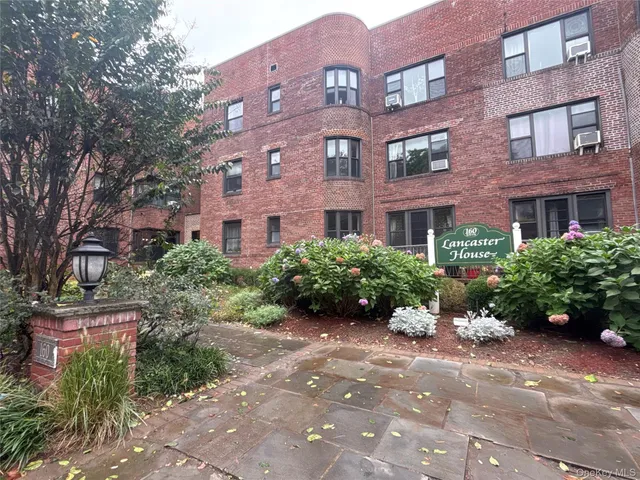 a view of a building next to a yard