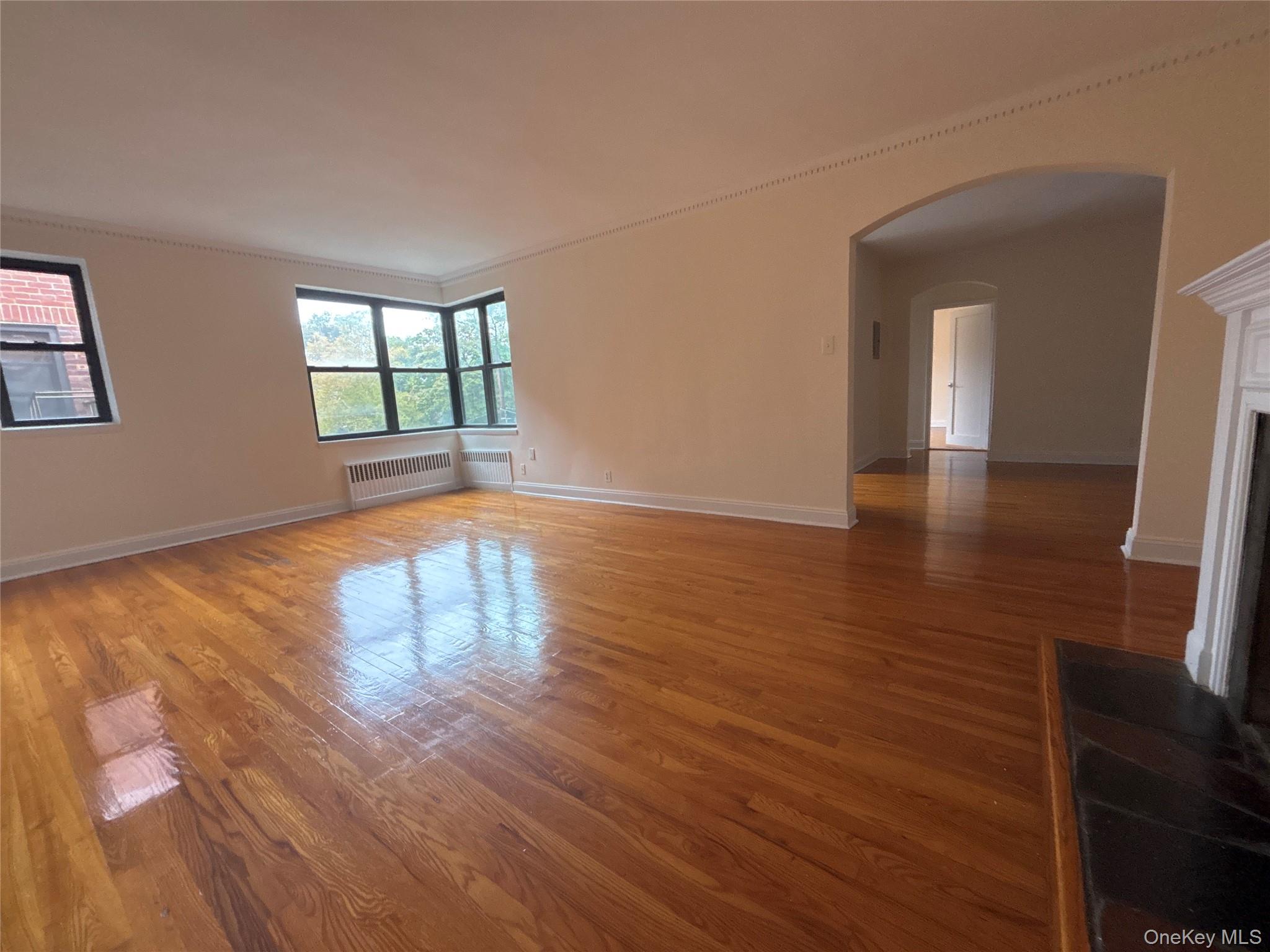 160 South Middle Neck Road, Unit 3C Great Neck, NY 11021 - Photo 12 of 19 a view of empty room with wooden floor and fan