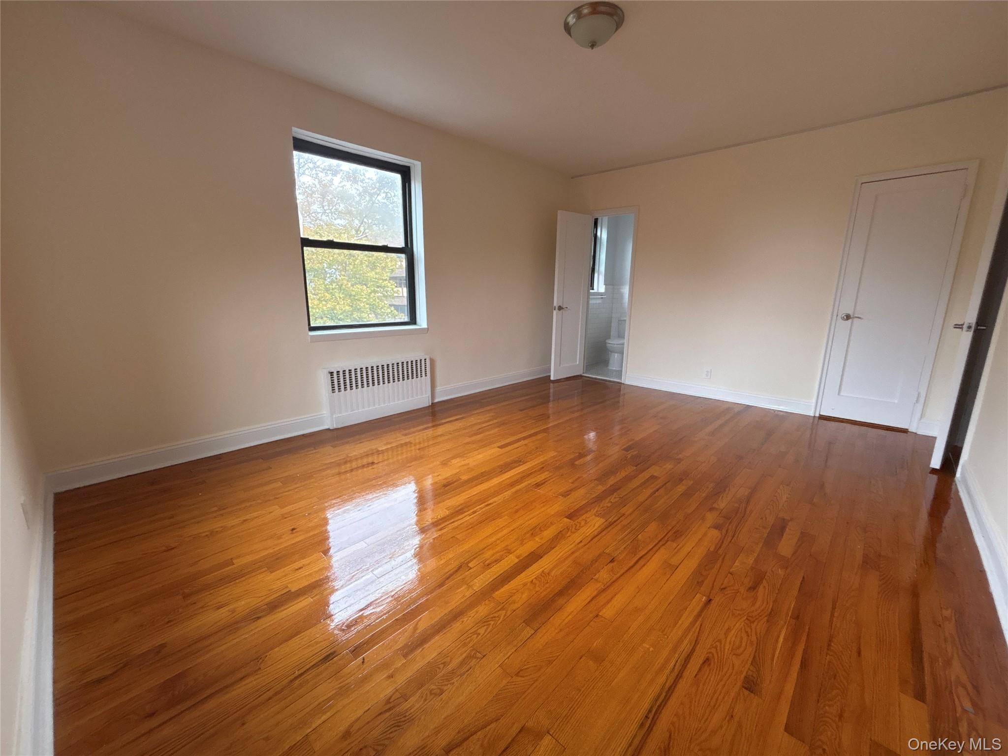 160 South Middle Neck Road, Unit 3C Great Neck, NY 11021 - Photo 13 of 19 an empty room with wooden floor and windows
