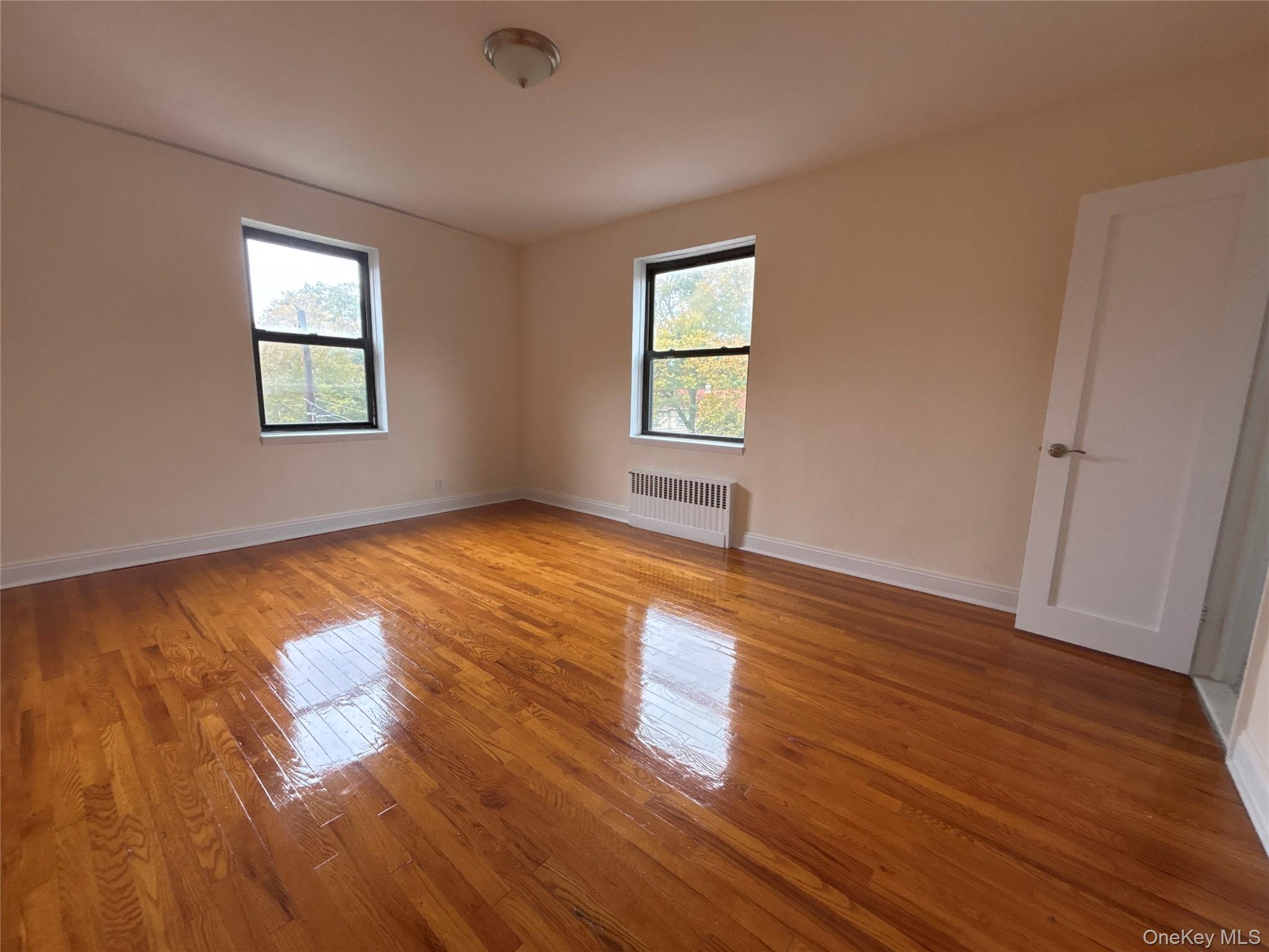 160 South Middle Neck Road, Unit 3C Great Neck, NY 11021 - Photo 14 of 19 a view of empty room with wooden floor and fan