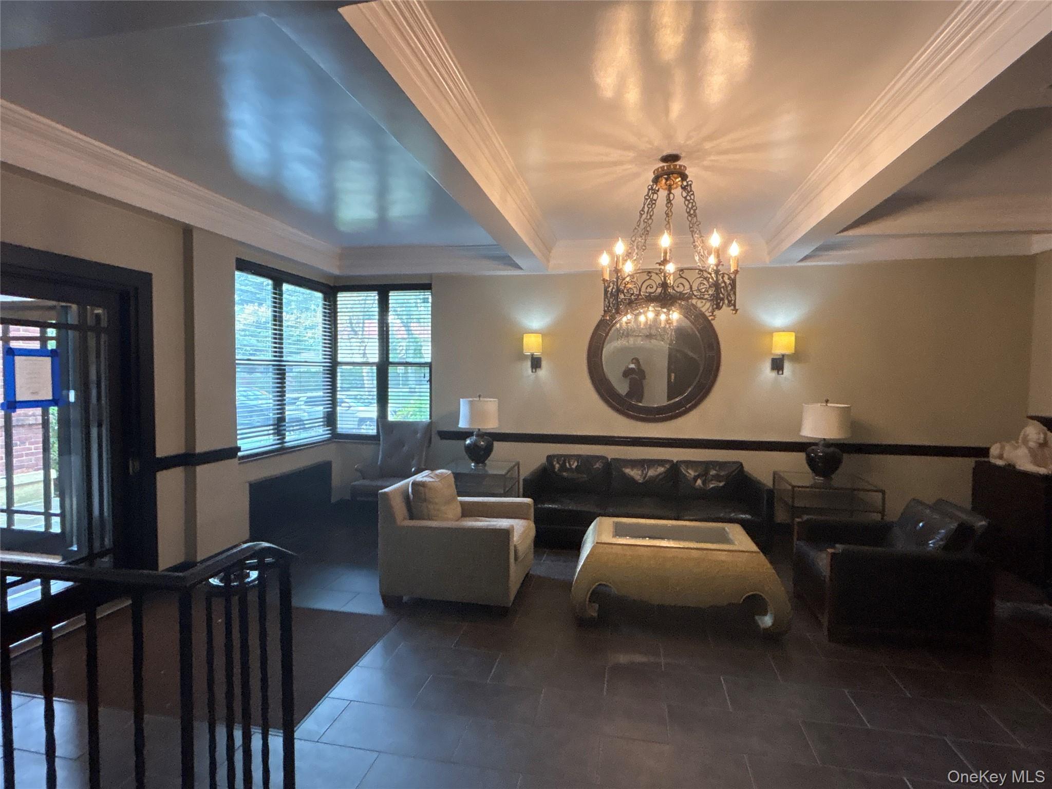 160 South Middle Neck Road, Unit 3C Great Neck, NY 11021 - Photo 3 of 19 a room with furniture a chandelier and a window