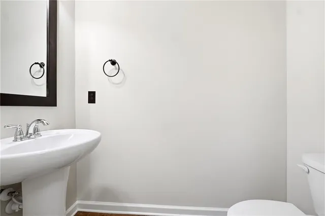 a bathroom with a sink mirror and toilet