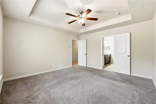 an empty room with closet and windows