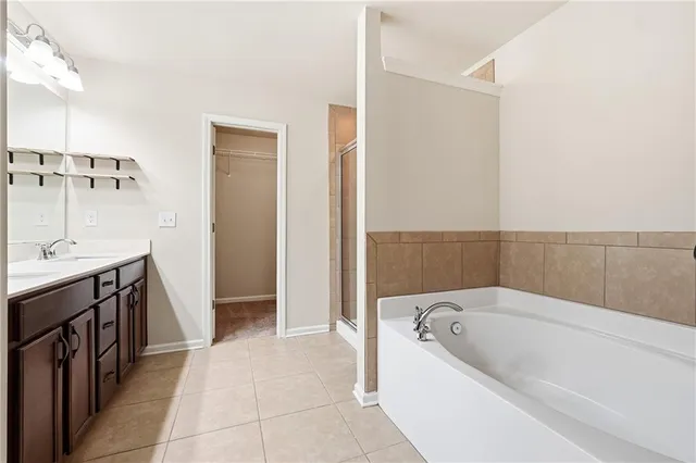 a spacious bathroom with a bathtub and a sink
