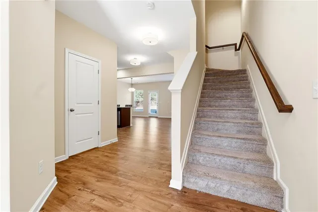 a view of entryway and hall with wooden floor