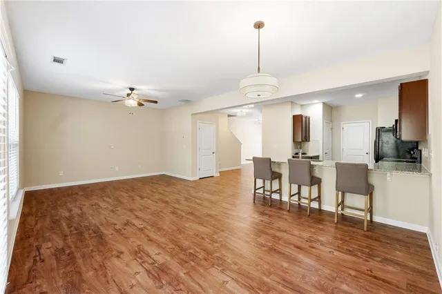 a view of a room with furniture and wooden floor