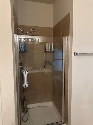 a bathroom with a glass shower door