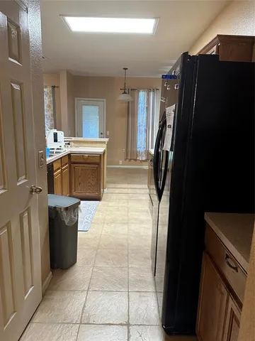 a kitchen with a refrigerator and a stove