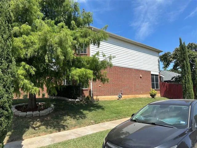 a view of a backyard with table and chairs and potted plants