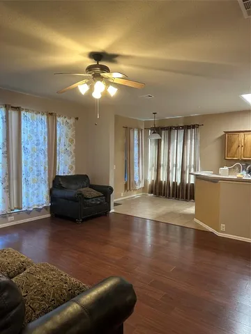 a view of a livingroom with furniture window and wooden floor