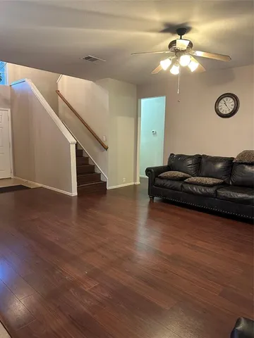 a view of a livingroom with furniture and a ceiling fan