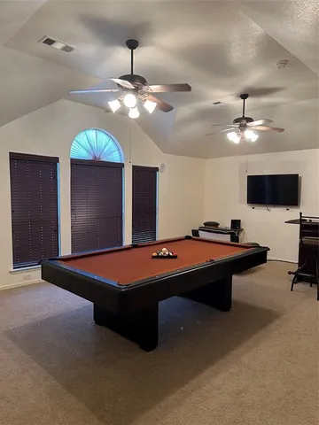 a room with pool table and flat screen tv