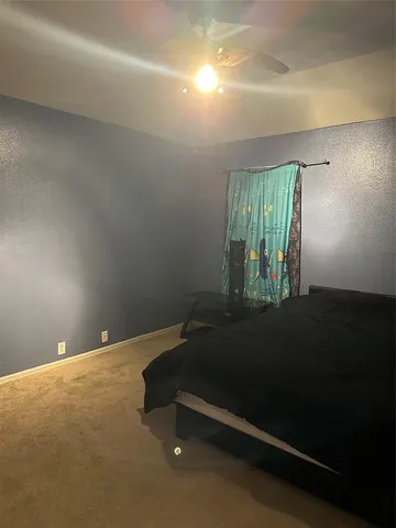 a room with pool table and windows