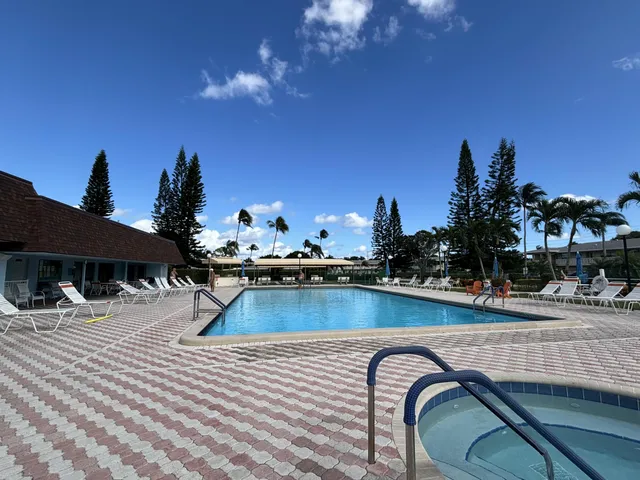 a view of a swimming pool with a lounge chairs