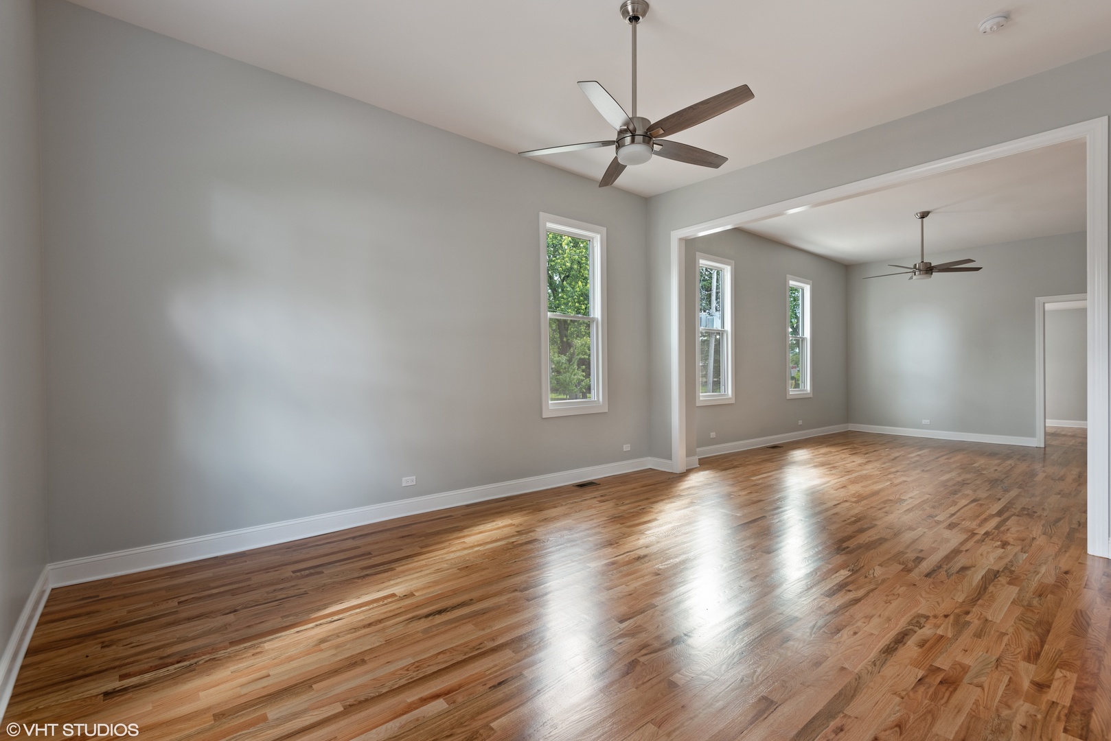 1131 Ridge Road, Unit 1 Wilmette, IL 60091 - Photo 2 of 14 a view of empty room with wooden floor and fan
