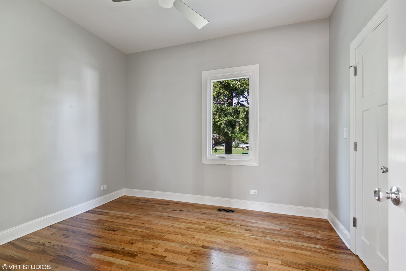 1131 Ridge Road, Unit 1 Wilmette, IL 60091 - Photo 12 of 14 a view of an empty room with wooden floor and a window