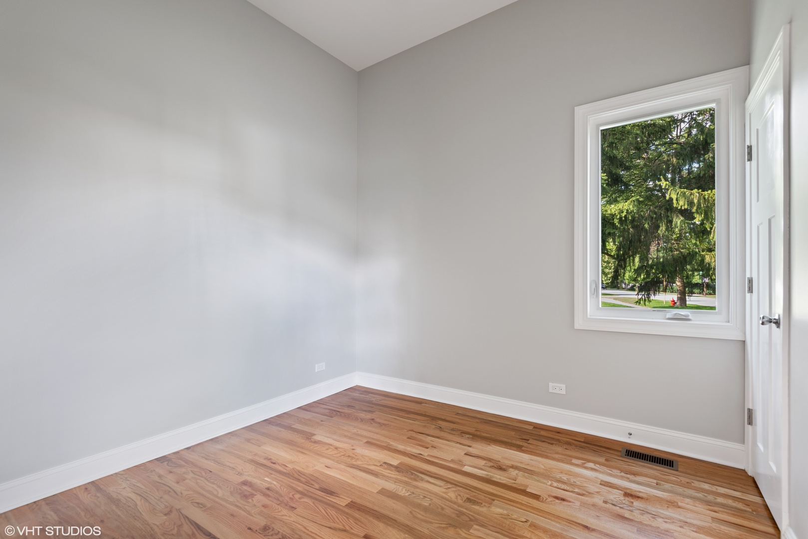1131 Ridge Road, Unit 1 Wilmette, IL 60091 - Photo 13 of 14 an empty room with wooden floor and windows