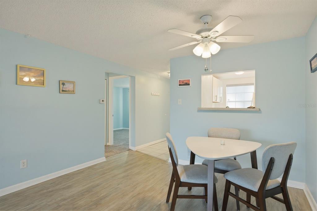 3309 Trophy Boulevard New Port Richey, FL 34655 - Photo 11 of 37 a view of a dining room with furniture and chandelier fan