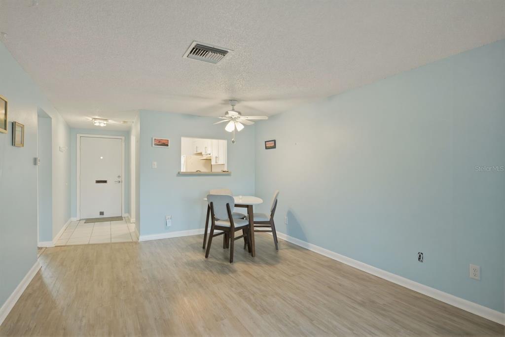 3309 Trophy Boulevard New Port Richey, FL 34655 - Photo 12 of 37 a view of a dining room with furniture and wooden floor