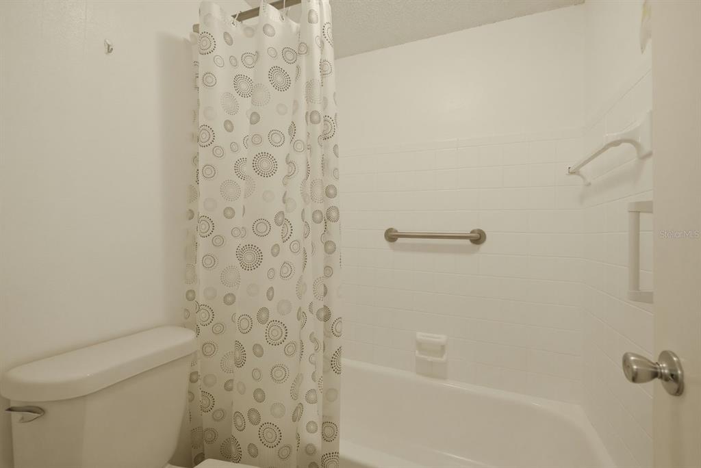 3309 Trophy Boulevard New Port Richey, FL 34655 - Photo 17 of 37 a bathroom with a shower and a toilet