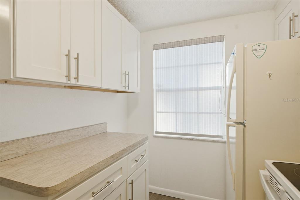 3309 Trophy Boulevard New Port Richey, FL 34655 - Photo 6 of 37 a view of a kitchen with white cabinets and a window