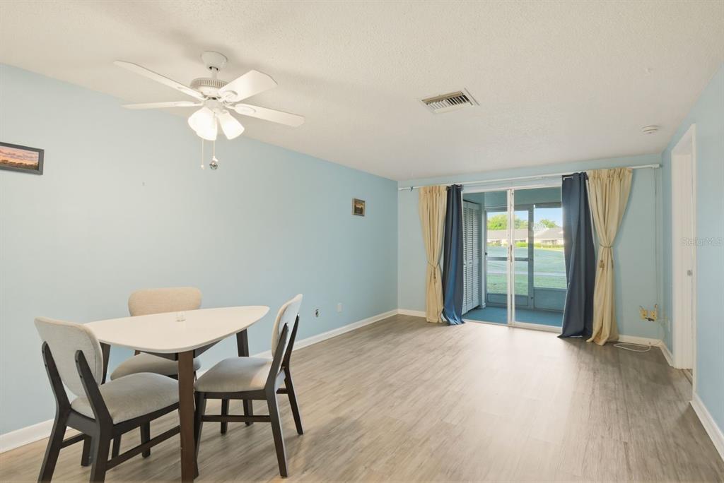 3309 Trophy Boulevard New Port Richey, FL 34655 - Photo 7 of 37 a view of a room with a wooden table and chairs