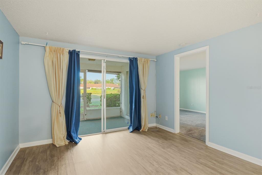 3309 Trophy Boulevard New Port Richey, FL 34655 - Photo 8 of 37 an empty room with wooden floor and windows