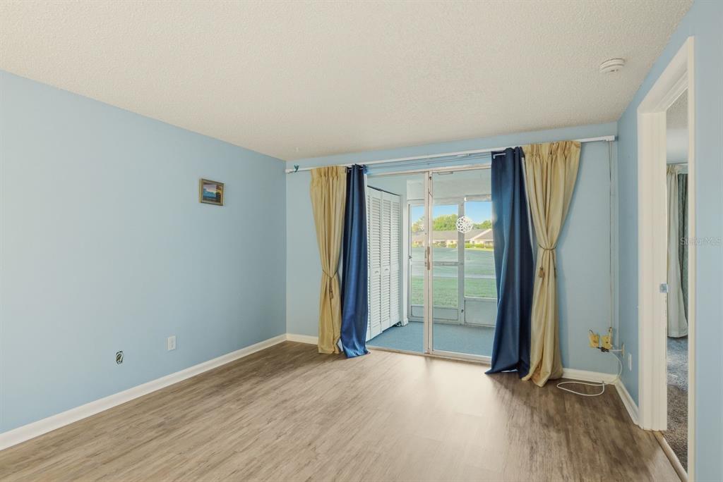 3309 Trophy Boulevard New Port Richey, FL 34655 - Photo 9 of 37 an empty room with wooden floor and a window