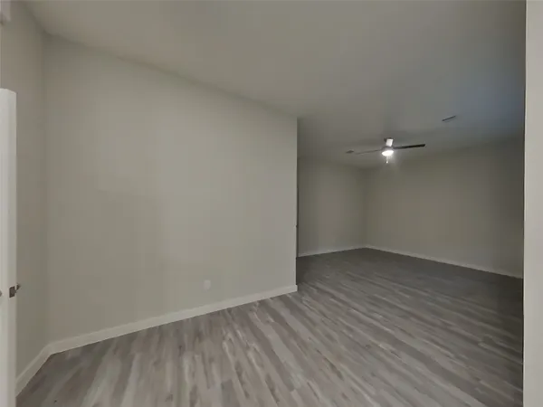 a view of an empty room and wooden floor