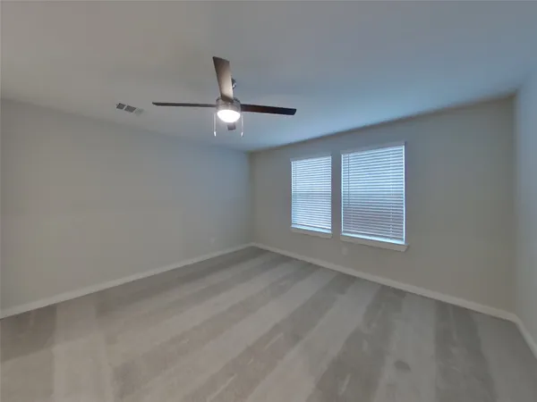 an empty room with a empty space and a ceiling fan