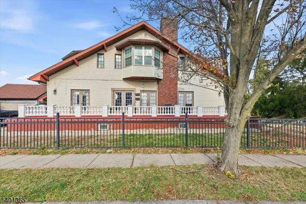 a front view of a house with a iron fence