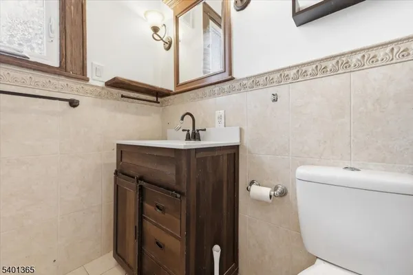 a bathroom with a sink a toilet and mirror