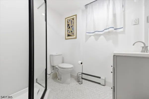 a white toilet sitting next to a bathroom sink