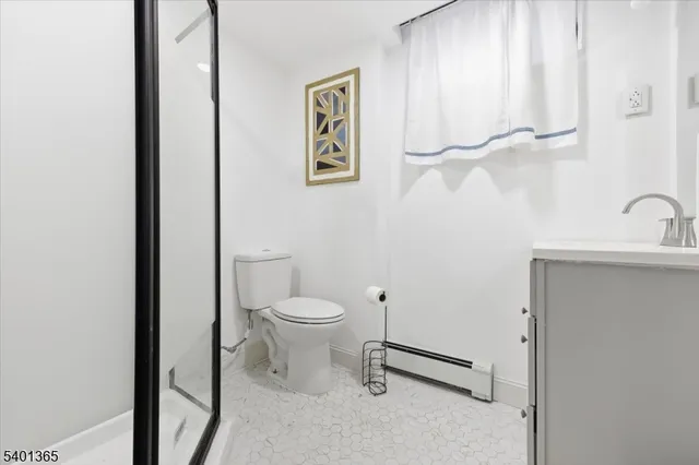 a white toilet sitting next to a bathroom sink