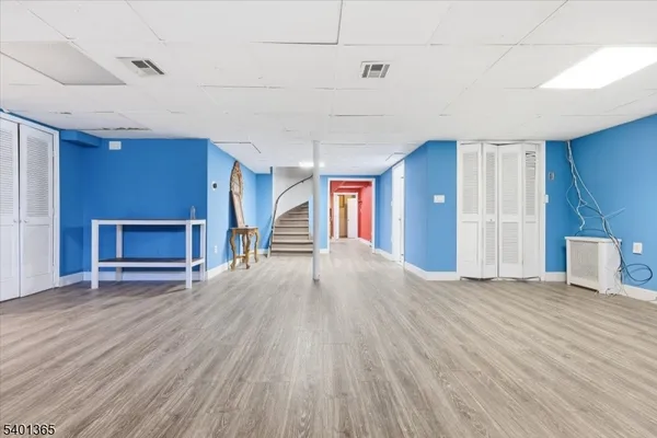 a view of empty room with wooden floor and fireplace
