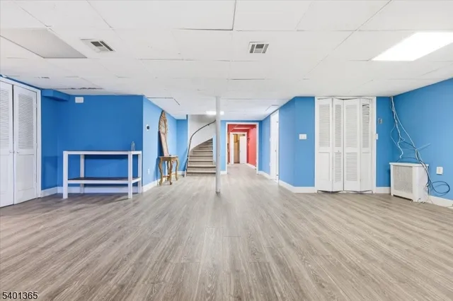 a view of empty room with wooden floor and fireplace
