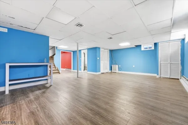 a view of an empty room with closet and a window