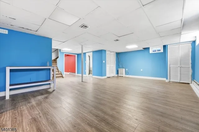 a view of an empty room with closet and a window
