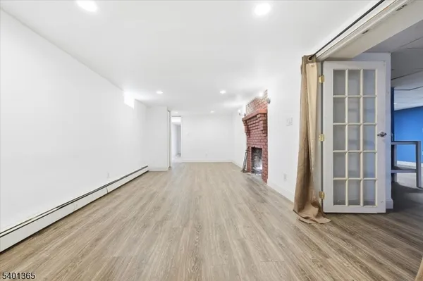 an empty room with wooden floor and a window