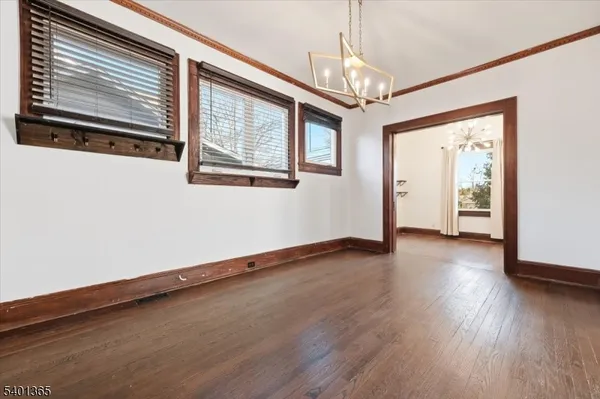 a view of a livingroom with wooden floor and windows