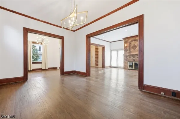 a view of a hallway with wooden floor and windows
