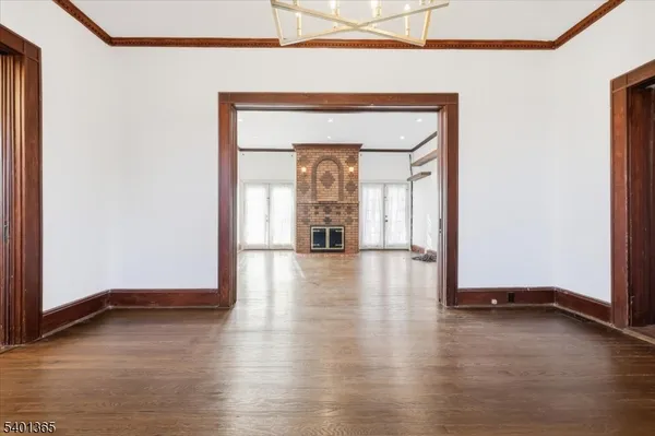 a view of a livingroom with wooden floor and a window