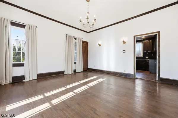 a view of a room with wooden floor closet and windows