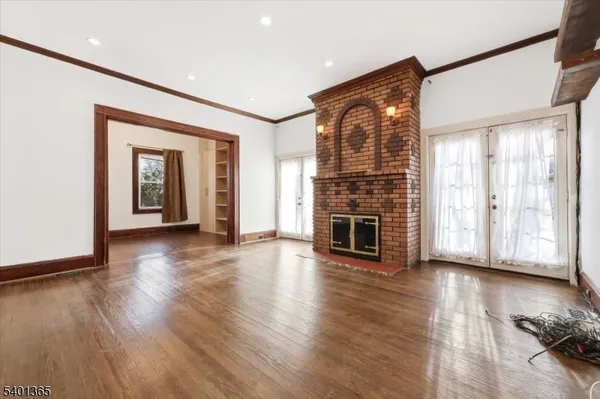a view of a livingroom with wooden floor and fireplace