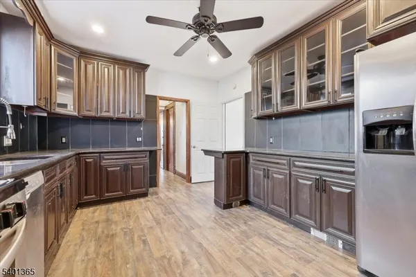 a kitchen with stainless steel appliances granite countertop a stove cabinets and wooden floor