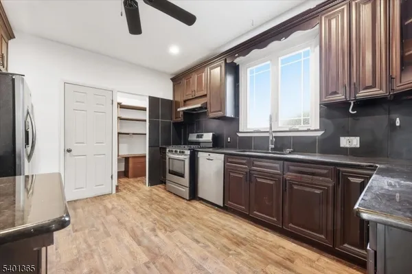 a kitchen with stainless steel appliances granite countertop a refrigerator and a sink