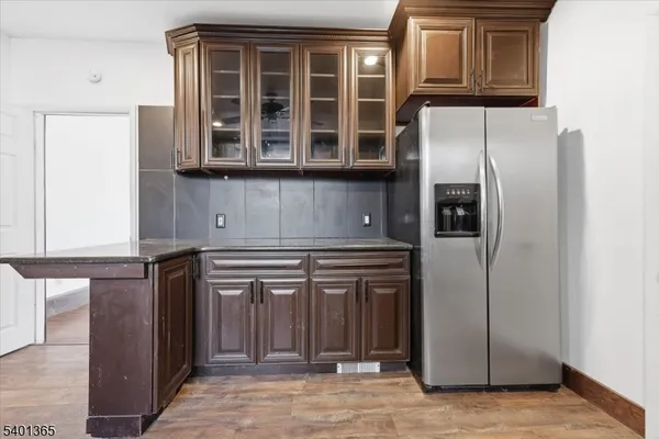 a kitchen with stainless steel appliances granite countertop a refrigerator and a stove
