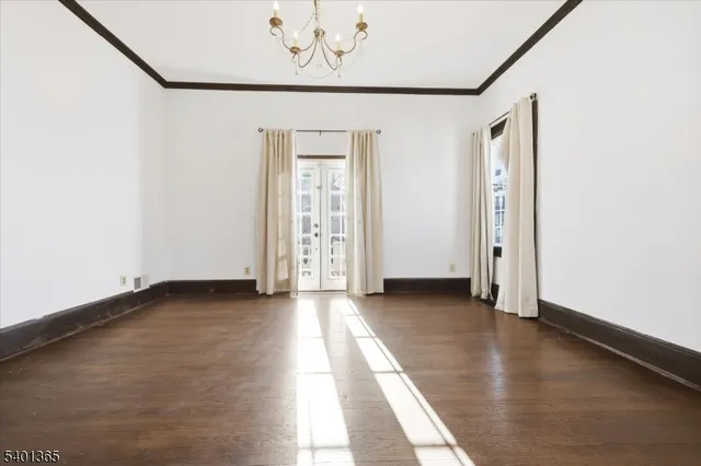 an empty room with wooden floor