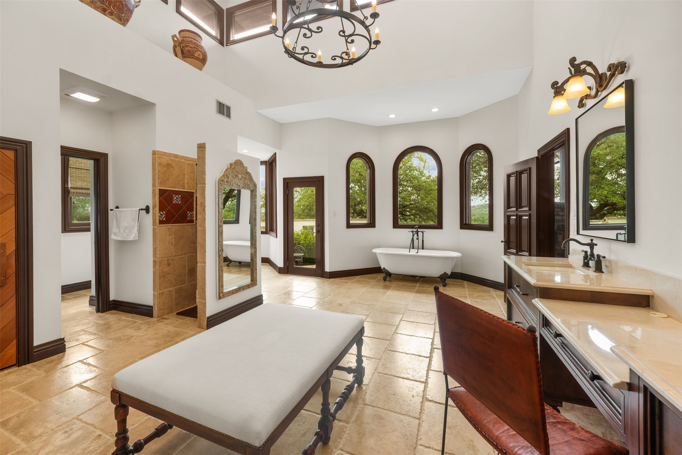 34000 Smithson Valley Road Bulverde, TX 78163 - Photo 20 of 50 The spa-inspired primary bath offers soaring ceilings, arched windows, a freestanding soaking tub, and elegant finishes throughout. Designed as a private sanctuary with abundant natural light and scenic views.